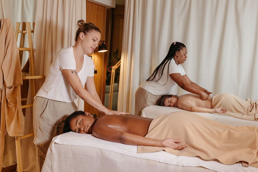 Couple receiving massages from two therapists